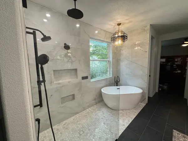 Warm neutral primary bathroom remodel in Pasadena with floating vanity and glass shower